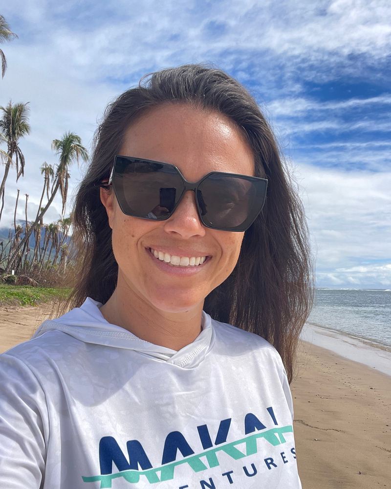 Iwa, co-owner, smiling on the beach